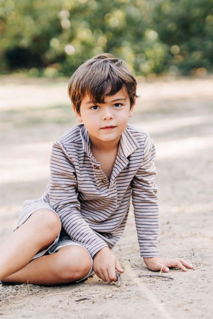 little boy in striped shirt sitting on the ground Pediatrician Santa Monica