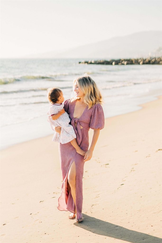mom holding her young daughter on the beach Santa monica baby stores