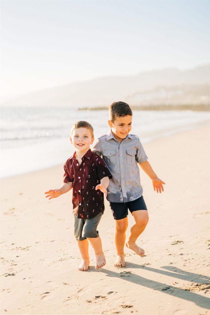 little boys playing on the beach and laughing Santa monica yoga studios